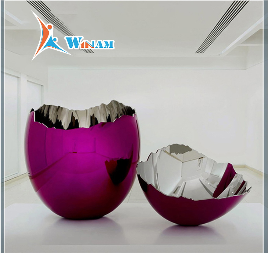 Large colorful stainless steel cracked egg sculpture